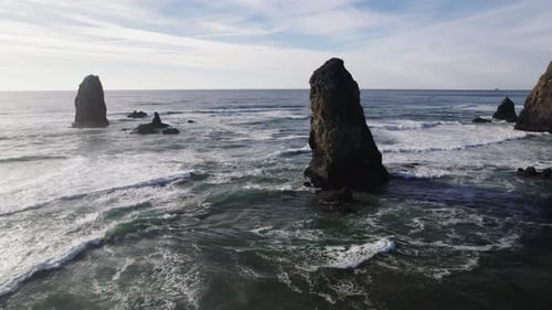 Rock formations tower over the ocean waves on the Pacific Coast