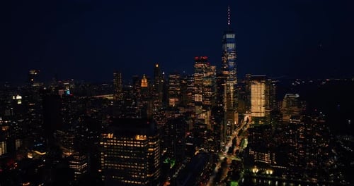 Vibrant New York with billions of lights. Drone footage descending above the night cityscape.