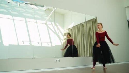 Graceful Ballerina Performing Classical Ballet Dance in a Studio