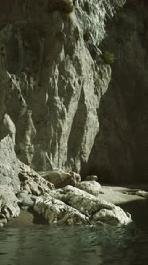 Rocky Cliffside By Calm Waters at Dusk