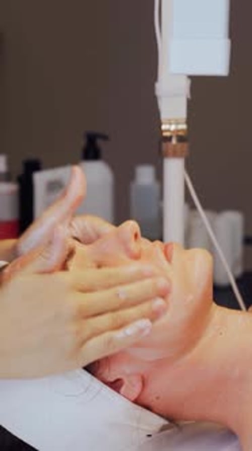 Woman Receiving Facial Massage at Beauty Salon