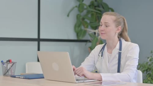 Online Video Chat by Female Doctor on Laptop in Clinic