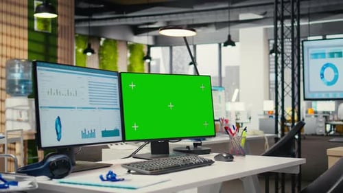 Modern Office Interior with Computer Screens and Green Screen