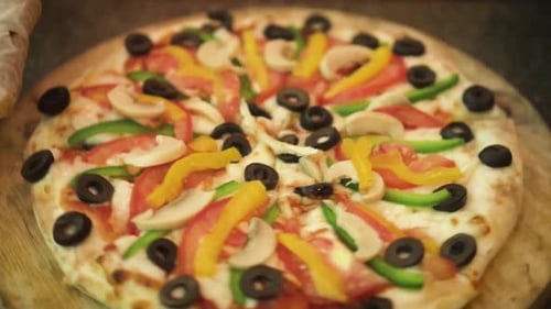 Close Up Of Showing Delicious Pizza Rotating By Hand