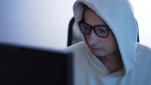 Computer Hacker Works at a Computer