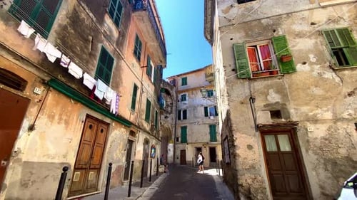 Person's POV Walking In The Narrow Street Of Ventimiglia With Clothes Hanging On The Buildings To Dr