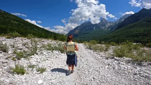 A woman walking on the trail on the Valbona Valley trekking to Theth, Theth National Park, Albanian