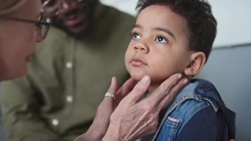 Cute Boy Having Check-up of Thyroid by Experienced Clinician in Hospital