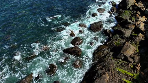 Waves Crashing Against Rocky Shoreline Water Splashing Over Coastal Boulders