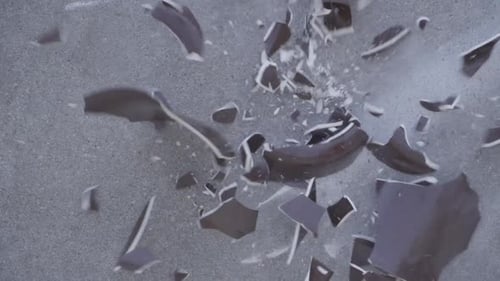 Top Down Slow Motion of Broken Brown Ceramic Pot Smashing on Concrete