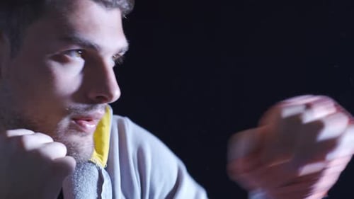 Close Up of Male Boxer Punching in Dark