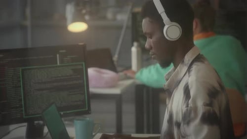 IT Specialist Working on Laptop in Office