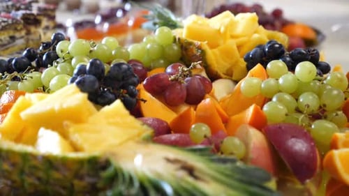 33. Fruit buffet. Grapes, pineapples, oranges, apples and others. Slow motion.