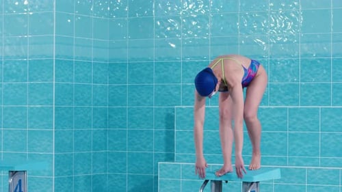 Young Attractive Beautiful Sportswoman Swimmer Dives Into the Pool Professional Water Jump in