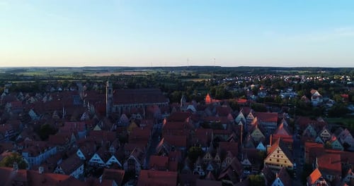 a drone flies to the side of the old town beautiful panorama at sunset