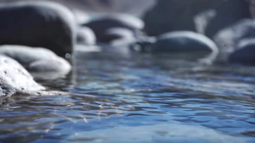 Transparent Lake Water With Rocks On The Shore During Summertime. - Selective Focus Shot