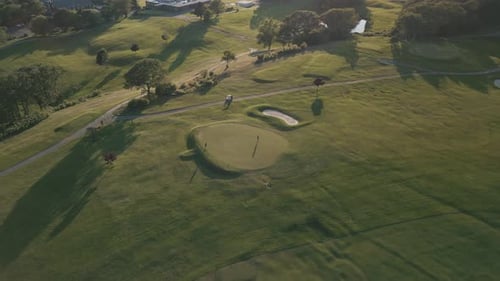 Aerial View of a Green Golf Course on a Summer Sunset Evening