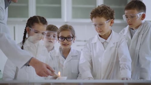 Children Observe Chemistry Experiment in School Lab