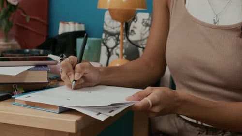 Woman Writing at Desk Indoors