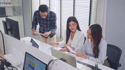 Group of Asian businessman and businesswoman working in the office.