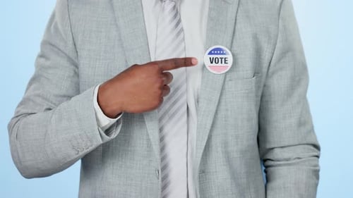 Hands, vote badge and man in politics, democracy and patriotism in studio isolated on a blue
