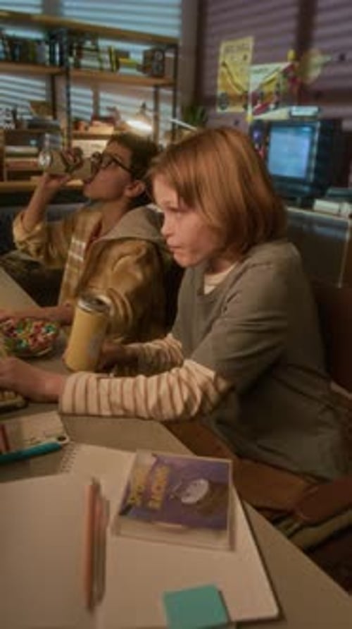 Two Children at Desk With Computer and Cans