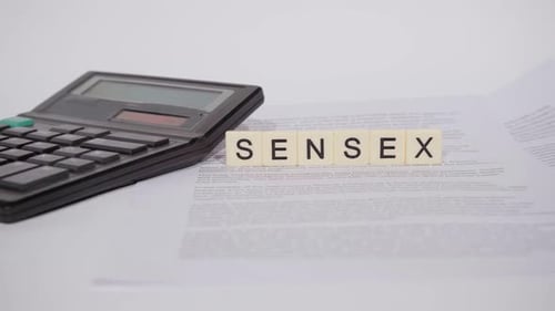 Calculator, Letters, and Document on a White Surface