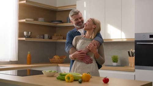 Loving Couple Embracing in Modern Kitchen