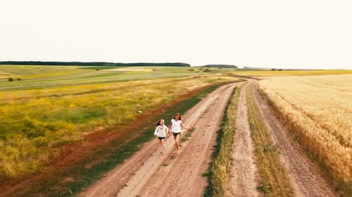 Two Little Toddlers Running on a Countryside Road