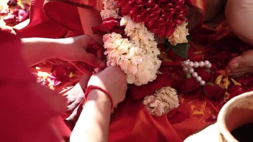 making indian bride wear silver anklet jewellery on her feet during an ongoing traditional hindu the