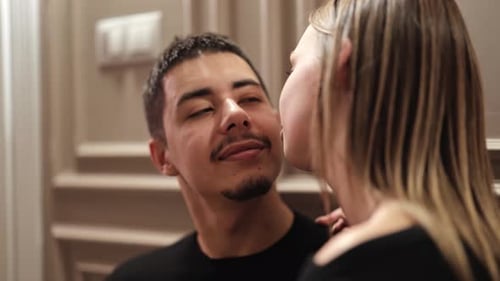 Affectionate Couple: Woman Kisses Man Tenderly on Cheek