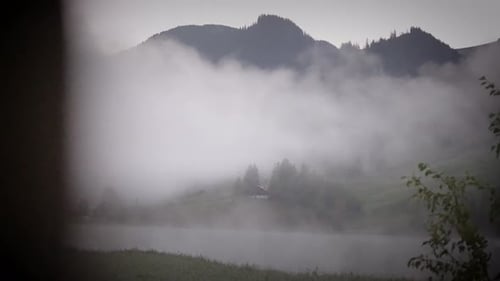 Dolly reveal small lake pond foggy morning