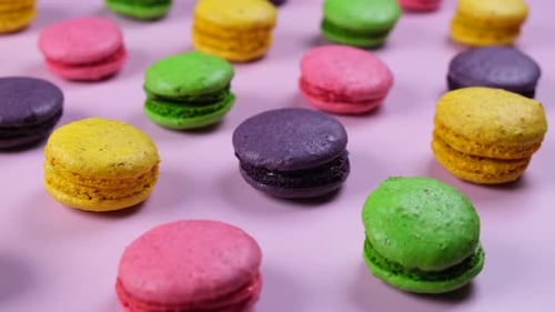 Colorful Macarons Displayed on Light Pink Background