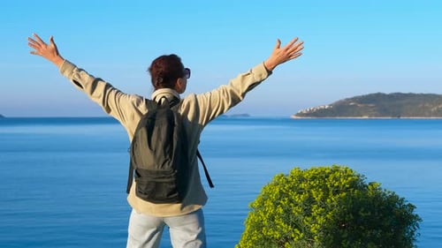 Female Tourist Opening Arms Enjoying Seascape View