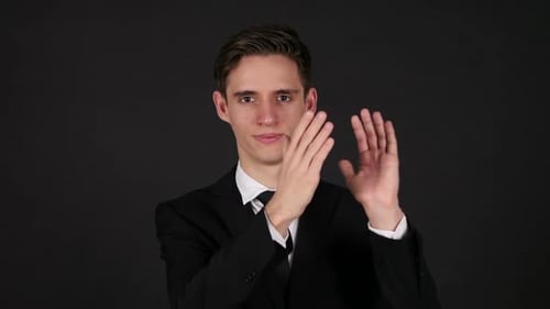 Young Adult Man Clapping in Black Suit