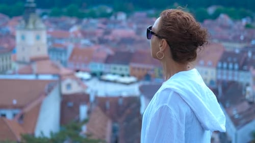 Woman Admiring Cityscape From High Vantage Point