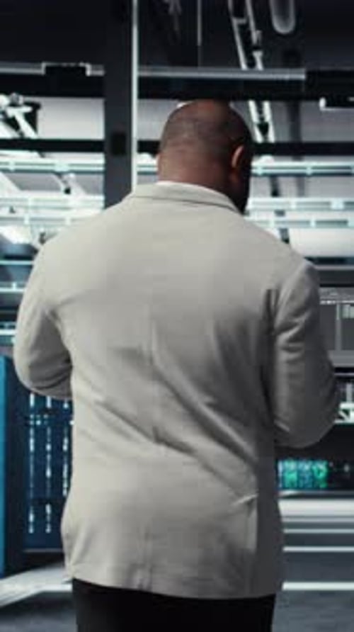 Vertical Video Data Center Technician Using Laptop to Manage Software Updates