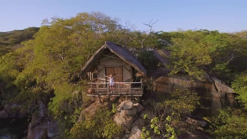 Tropical Island Resort: Woman on Hut Balcony Relaxation