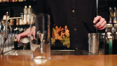 Young Bartender Doing a Cocktail with Shaker in the Bar Man Making Alcohol Cocktail Behind the Bar