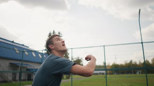 Young Man Playing Volleyball on Outdoor Court