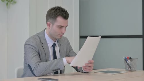 Young Adult Celebrating Good News in Office