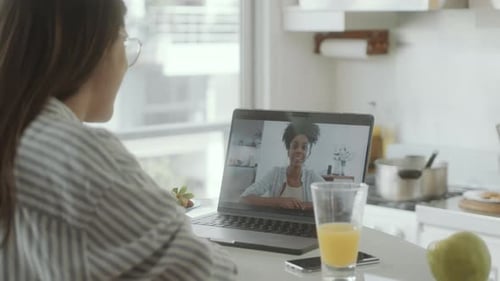 Woman Video Chatting with Friend in Kitchen