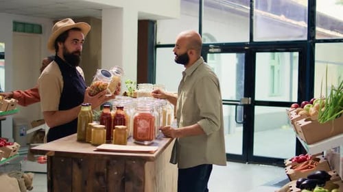 Employee Assists Customer at Food Store Counter