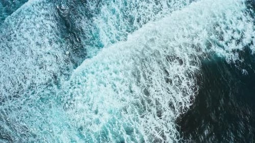 Aerial View of Ocean Waves Crashing