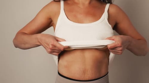 Empowerment Story Woman Holds Removed Breast Implants After Surgery