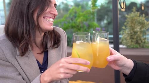 Friends Sharing Cocktails and Celebrating in Urban Setting