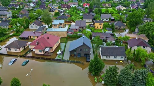 Drone captures extensive flooding in residential area with brown water covering streets and homes