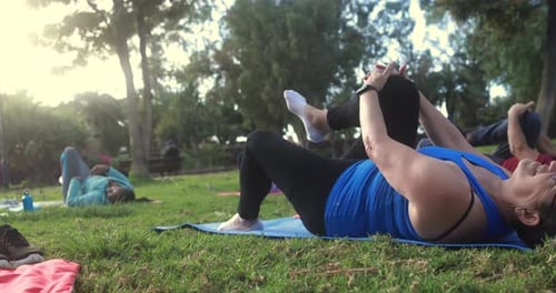 Multiracial senior people doing yoga exercises outdoor with city park in background