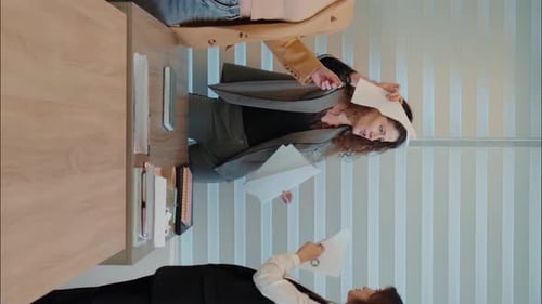 Vertical Screen Three business woman celebrating success dancing at workplace.