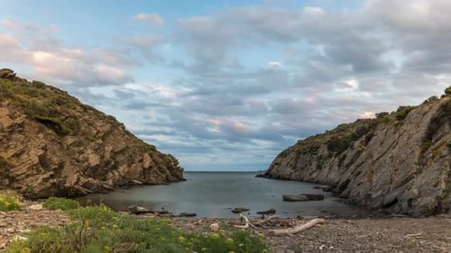 Moving Clouds Above Calm Ocean With Rocky Valley During Sunset. Timelapse